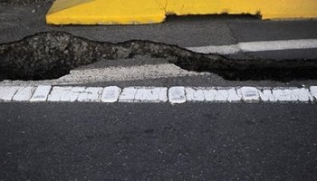 Photo illustration shows cracked asphalt after quake
