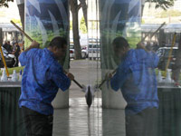 A window washer works on the Hawaii Convention Center