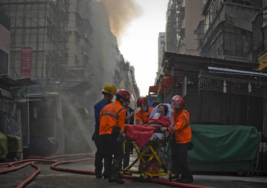 Rescuers help an injured person in Hong Kong