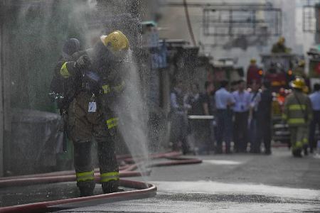 Rescuers work at the site of a fire in downtown Hong Kong