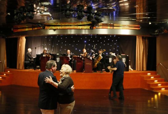 Passengers on the Titanic Memorial Cruise dance